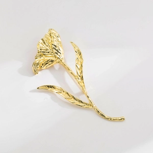 Detail view of gold tulip brooch showing intricate metallic pleats and wavy texture details