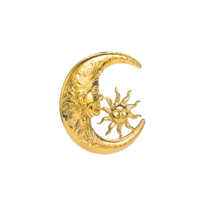 Detailed macro shot of vintage sun and moon brooch with intricate face relief engraving