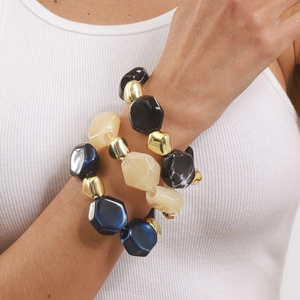 Chunky elastic bracelet featuring colorful resin beads and metallic accents on model