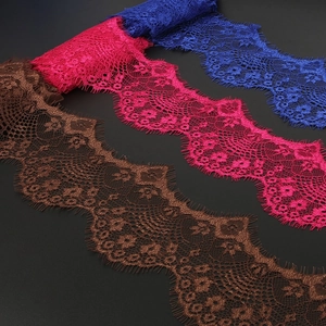 Detailed view of floral eyelash lace ribbons in royal blue, magenta, and brown colors
