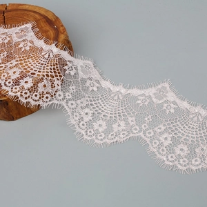 Detailed view of light pink floral eyelash lace trim for DIY clothing accessories
