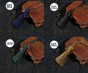 Detailed close-up of handmade silk tassels in navy, coffee, dark green and earthy yellow