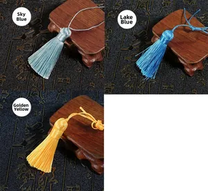 Detailed view of silk tassels in sky blue, lake blue, and golden yellow colors
