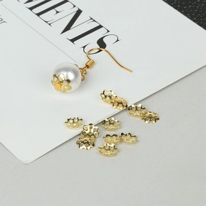 Close-up of golden hollow flower bead caps for DIY jewelry earring making projects