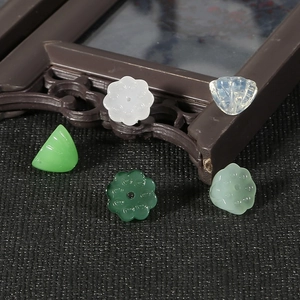 Detailed view of assorted jade-like resin lotus and leaf charms for DIY jewelry making