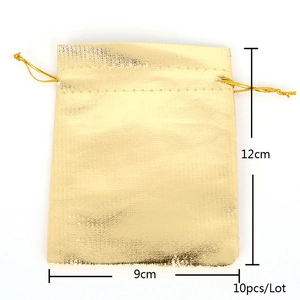 Macro shot of gold metallic drawstring gift pouch with woven texture for jewelry
