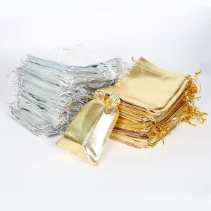 Metallic gold and silver drawstring organza pouches for jewelry and small gift packaging