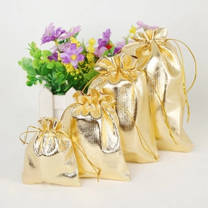 Metallic gold drawstring gift bags for jewelry storage in four different sizes