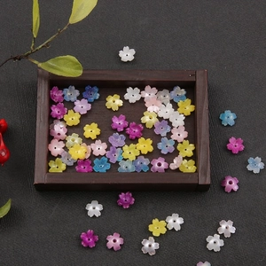 Colorful resin floral beads for DIY jewelry and hair accessories on wood tray