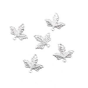 Detailed view of silver hollow maple leaf charms with intricate veins for DIY jewelry