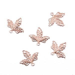 Detail of five rose gold hollow leaf charms with intricate veins for DIY jewelry making
