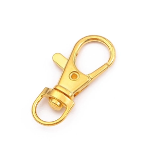 Close-up of golden swivel lobster clasp with rotating D-ring for DIY keychains