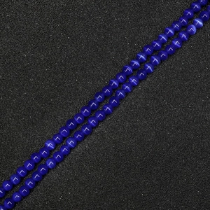 Macro detail of dark blue round cat eye stone beads for DIY jewelry making