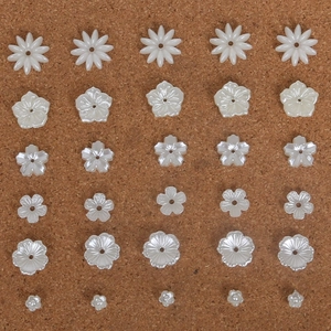 Detailed view of white ABS pearl flower beads for DIY jewelry and hair accessories