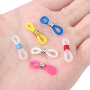 Close-up of colorful silicone eyeglass chain connectors with metal spring coils held in hand
