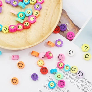Close-up of colorful polymer clay smiley face flower beads for DIY jewelry making