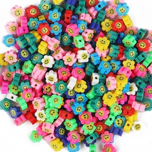 Close-up of colorful polymer clay flower beads with smiley faces for DIY jewelry making