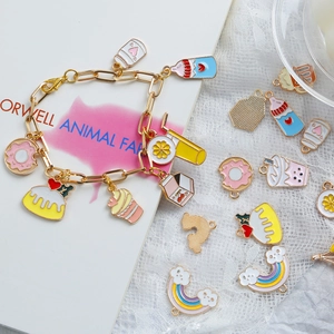 Gold chain bracelet with colorful enamel donut and rainbow charms for DIY jewelry making