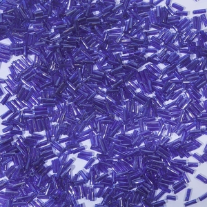 Macro detail of royal blue bugle beads made of polished glass for DIY jewelry making