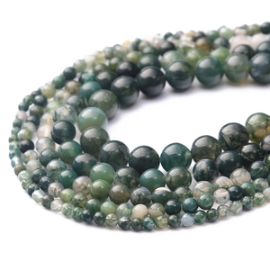 Macro detail of various sizes of moss agate beads for DIY jewelry making