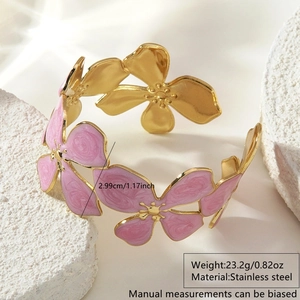 Elegant gold stainless steel open bangle with a large pink enamel flower and specifications