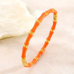 Bracelet jonc style bambou en acier inoxydable émaillé orange avec détails dorés