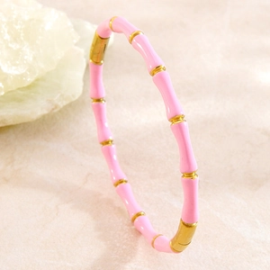 Détail macro du bracelet jonc en émail rose et acier inoxydable doré à l'or 18 carats