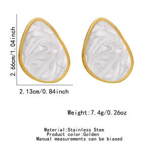 Detailed view of teardrop earrings in gold stainless steel with marble texture