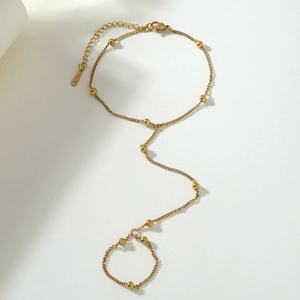Elegant gold stainless steel finger chain bracelet featuring delicate beads and Y-shape design
