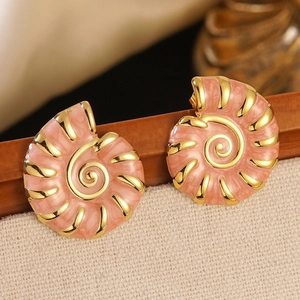 Macro view of pink enamel nautilus earrings with gold accents and marble texture