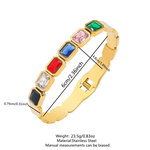 Detailed size view of a gold stainless steel bangle with emerald cut colored stones