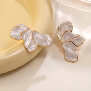 Artistic gold irregular petal earrings with marble resin inlay on ceramic tray