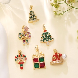 Christmas necklace pendants with festive snowmen, trees, and gift box charms in gold finish