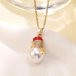 Close-up of a snowman pendant with white faux pearl and red enamel Christmas hat detail