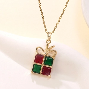 Detailed close-up of a festive gift box pendant with red and green cubic zirconia stones