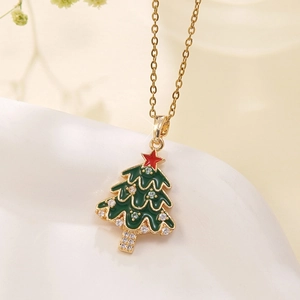 Macro detail of Christmas tree pendant with green enamel and sparkling white zircons