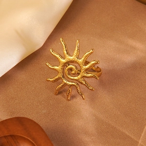 Vintage sunburst gold ring with hammered texture and adjustable open band on silk