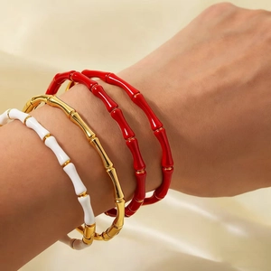 Bamboo style stainless steel stackable bangles in red, gold, and white enamel finish