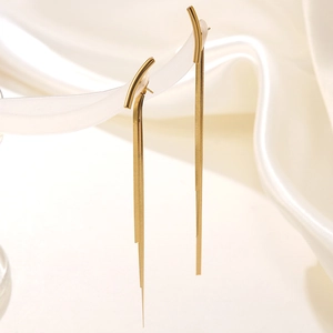Elegant gold plated stainless steel long tassel earrings draped over silk fabric