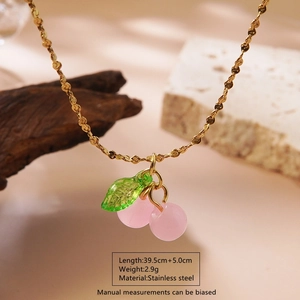 Pink cherry pendant necklace in stainless steel with 39.5cm gold chain on natural stones