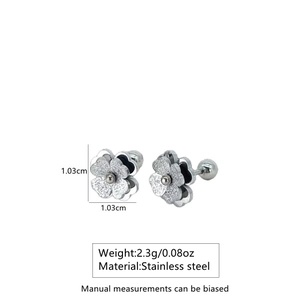 Detail view of flower stud earrings in stainless steel with textured finish and screw back