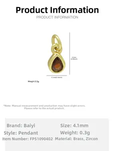 Detailed view of 18k gold plated brass teardrop pendant with dark red zircon stone