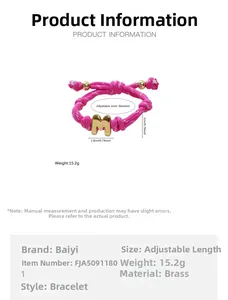 Detail of adjustable pink braided rope bracelet with golden letter M pendant and measurements