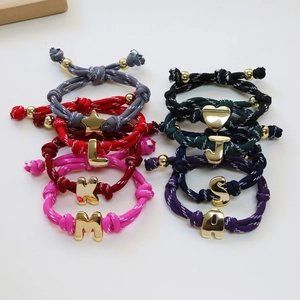 Colorful woven letter bracelets set in 18k gold plated brass with adjustable cords