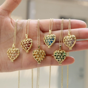 Detailed view of heart-shaped gold pendants featuring vibrant faceted birthstones in six colors