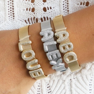 Detail of adjustable mesh band bracelets with sparkling zircon initial letters for women