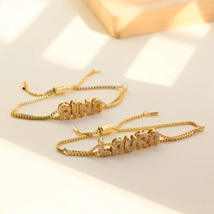 Custom gold box chain bracelets with sparkling zircon bubble letters RINA and LAURA