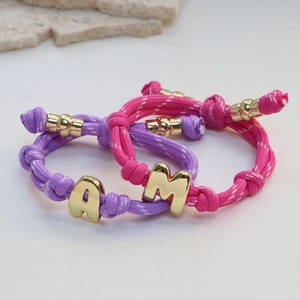 Pink and purple woven rope bracelets with gold metallic A and M alphabet sliders
