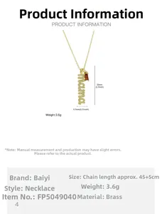 Detail of mama gold necklace showing dimensions 33mm by 6.3mm and red birthstone