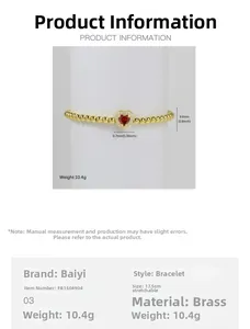 Detail of 18k gold heart charm elastic bead bracelet with red stone and measurements